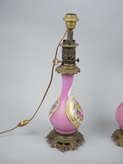Pair of porcelain oil lamps with polychrome...