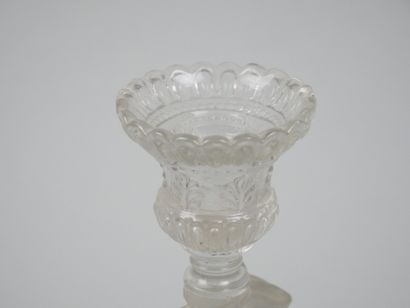 A pair of candlesticks in partially frosted...