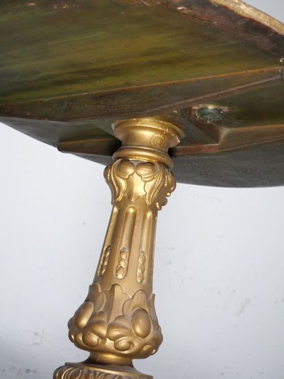 Gilded wood pedestal table carved with scrolls...