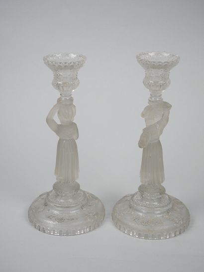 A pair of candlesticks in partially frosted...
