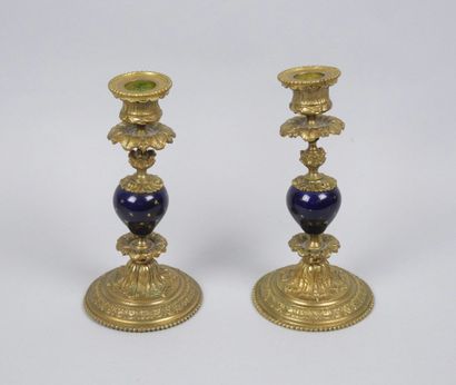 Pair of gilt bronze candlesticks decorated...