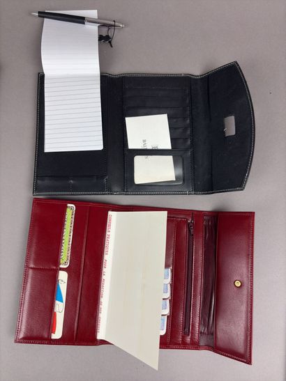Set of two red leather wallets decorated...