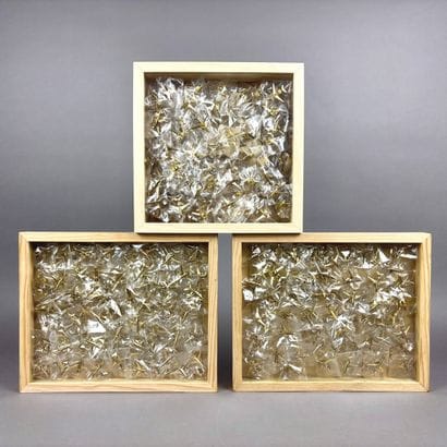 A collection of numerous gold pins depicting...