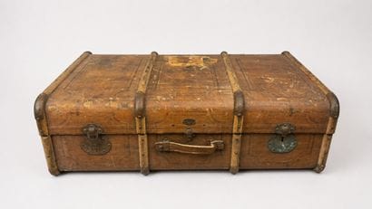 Wooden travel trunk partially lined with...