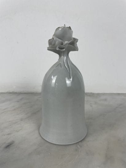 Decorative white porcelain bell in the shape...