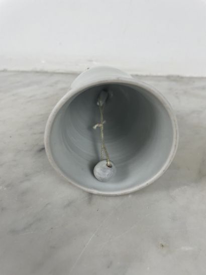 Decorative white porcelain bell in the shape...