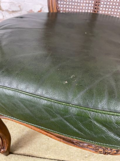 Fauteuil en bois sculpté, cannage et cuir...