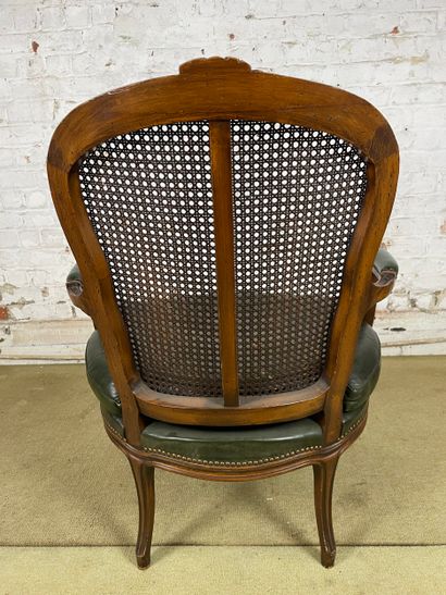 Fauteuil en bois sculpté, cannage et cuir...