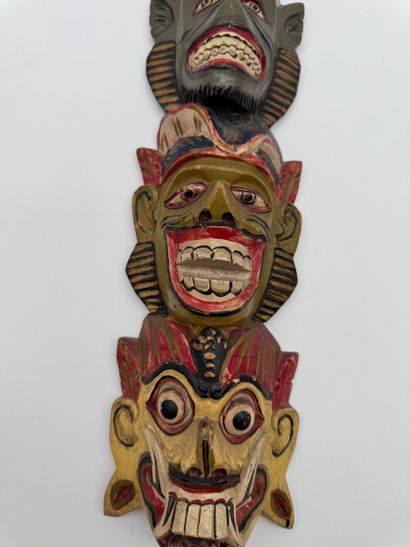 Carved wood wall totem with mask decoration
Carved...