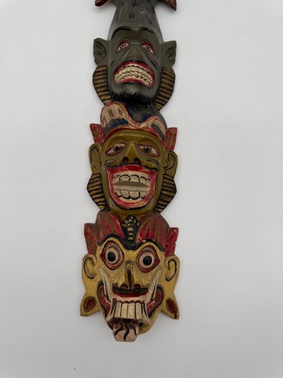 Carved wood wall totem with mask decoration
Carved...