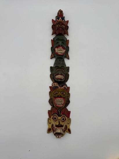 Carved wood wall totem with mask decoration
Carved...