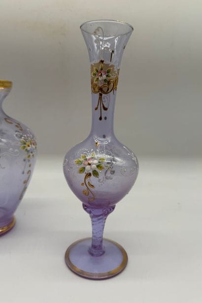 Two violet-colored glass vases decorated...
