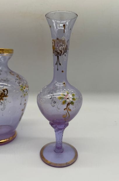 Two violet-colored glass vases decorated...