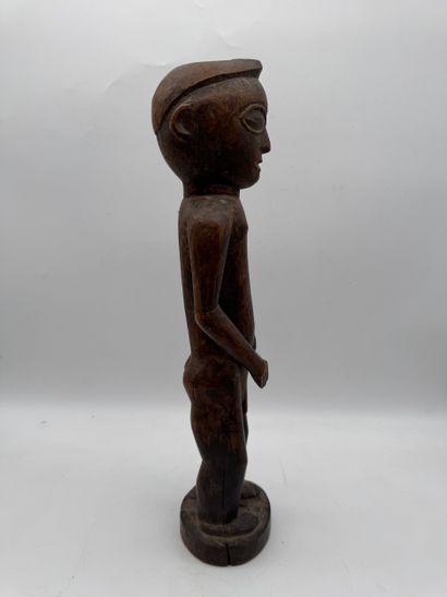 MALE STATUETTE
Mid-20th century. Wood with...