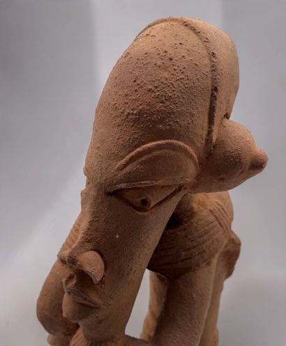 KNELT FIGURE, IN THE STYLE OF THE NOK CULTURE...