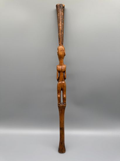 STICK WITH A FEMALE FIGURE 
Light wood. Incised...