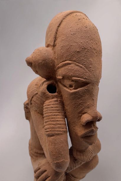 KNELT FIGURE, IN THE STYLE OF THE NOK CULTURE...