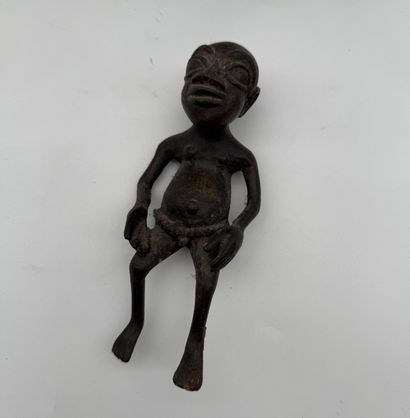 SEATED FEMALE FIGURE HOLDING A STATUETTE
Mid-20th...