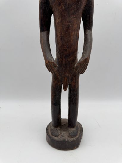 MALE STATUETTE
Mid-20th century. Wood with...