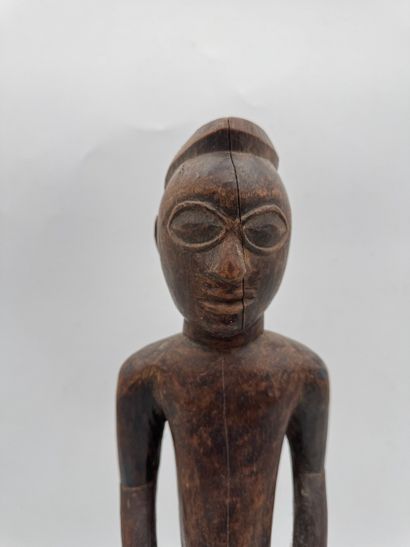 MALE STATUETTE
Mid-20th century. Wood with...