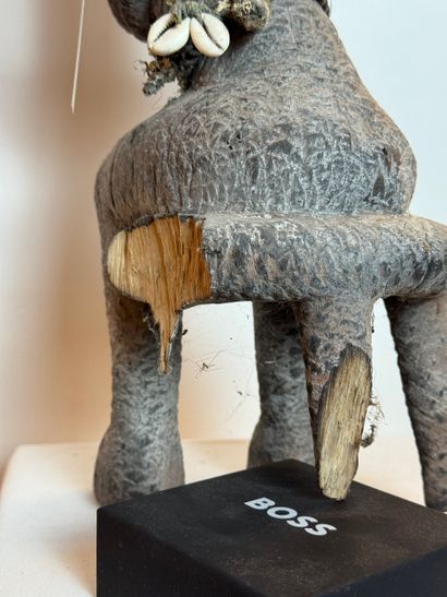 SEATED FEMALE FIGURE WEARING A BOWL ON HER...