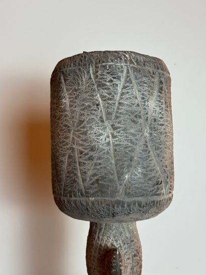 SEATED FEMALE FIGURE WEARING A BOWL ON HER...