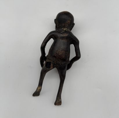 SEATED FEMALE FIGURE HOLDING A STATUETTE
Mid-20th...