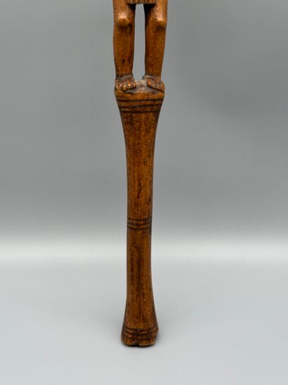 STICK WITH A FEMALE FIGURE 
Light wood. Incised...