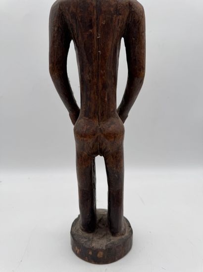 MALE STATUETTE
Mid-20th century. Wood with...