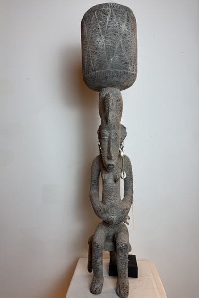 SEATED FEMALE FIGURE WEARING A BOWL ON HER...