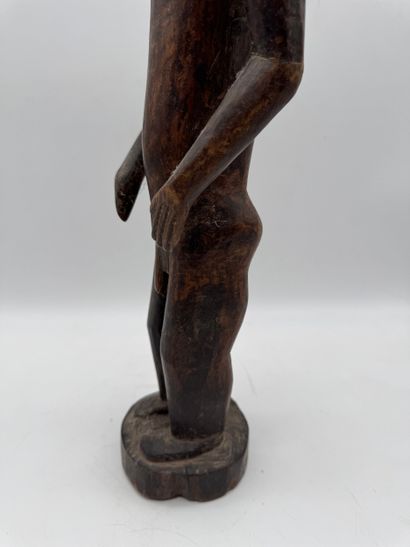 MALE STATUETTE
Mid-20th century. Wood with...