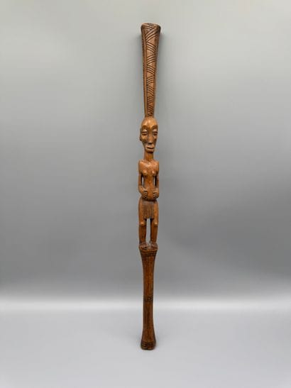 STICK WITH A FEMALE FIGURE 
Light wood. Incised...