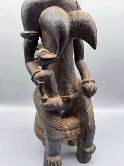 MOTHER WITH CHILD SEATED ON A STOOL, SENOUFO,...