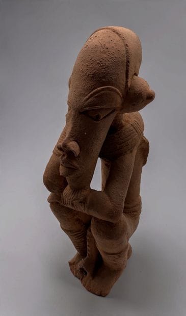 KNELT FIGURE, IN THE STYLE OF THE NOK CULTURE...