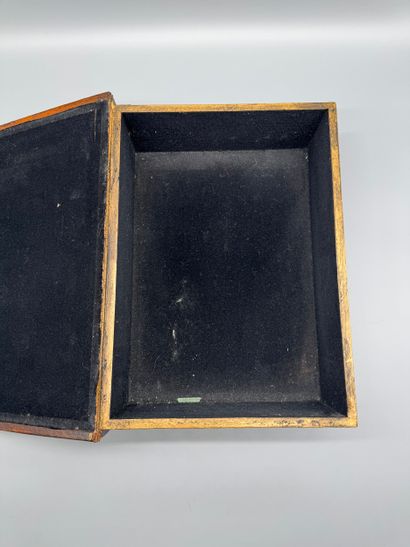 A trompe-l’œil box shaped like a book, covered...