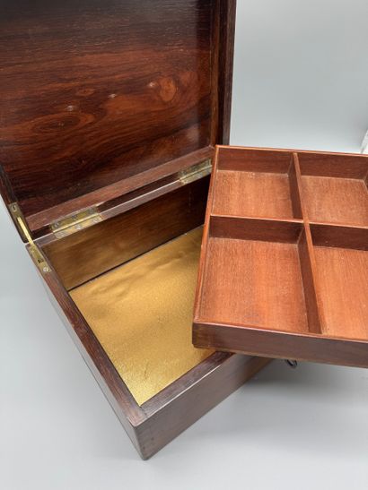 Wooden travel case with a hinged lid, featuring...