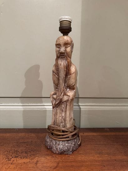 Carved stone lamp depicting a Chinese sage
Monolithic...