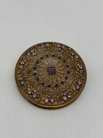 Small powder compact with a mirror, made...