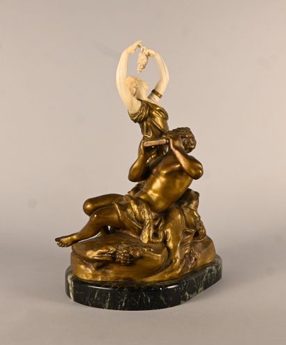 Bronze and ivory group depicting a faun playing...