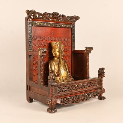 Gilded wooden statue of a dignitary seated...