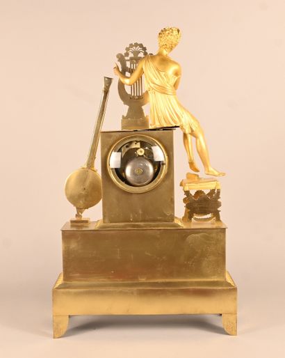 Empire-style gilt bronze clock with musical...