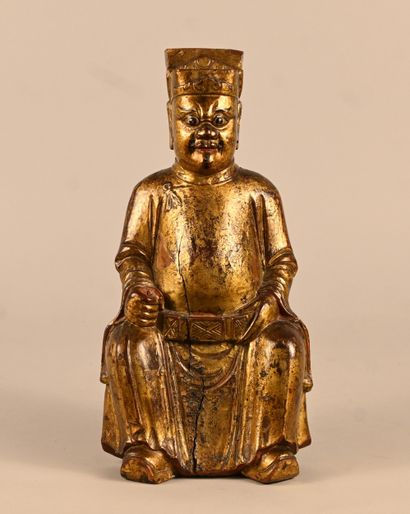 Gilded wooden statue of a dignitary seated...