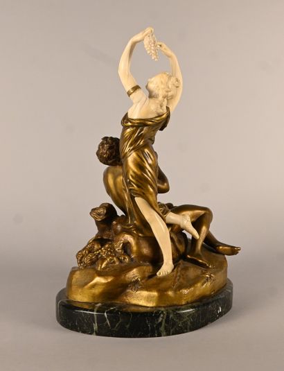 Bronze and ivory group depicting a faun playing...