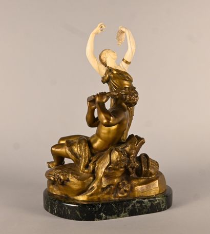 Bronze and ivory group depicting a faun playing...