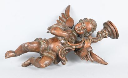 Carved wood wall light featuring a winged...
