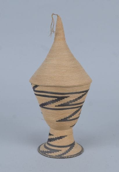 Tutsi agaseke on pedestal in woven plant...