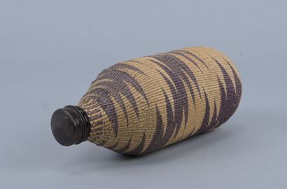 Tutsi bottle covered with wavy raffia basketry...