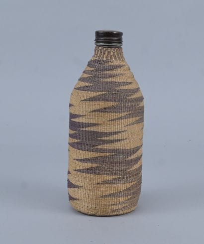 Tutsi bottle covered with wavy raffia basketry...