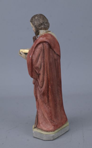 Saint holding a book, religious statue in...
