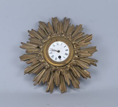 Bronze wall clock in the shape of a sun,...